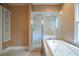Bathroom featuring a soaking tub with tile surround and a separate glass-enclosed shower at 1276 Lanier Ne Blvd, Atlanta, GA 30306