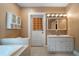 Spacious bathroom with double sink vanity, soaking tub, and linen storage cabinet at 1276 Lanier Ne Blvd, Atlanta, GA 30306