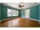 Bedroom with original hardwood floors, windows, ceiling fan and door to exterior at 1276 Lanier Ne Blvd, Atlanta, GA 30306