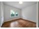 Bedroom featuring wood floors, white walls and trim, and natural light from a window at 1276 Lanier Ne Blvd, Atlanta, GA 30306