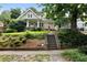 Charming two-story home with stone stairs, landscaped yard, and inviting front porch at 1276 Lanier Ne Blvd, Atlanta, GA 30306