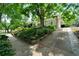 A charming two-story house featuring lush landscaping, a spacious driveway, and mature trees at 1276 Lanier Ne Blvd, Atlanta, GA 30306