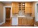 Kitchen with white dishwasher, light wood cabinets, tile backsplash and floors at 1276 Lanier Ne Blvd, Atlanta, GA 30306