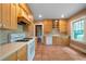 A view of the kitchen featuring tile floors, white appliances, and light wood cabinets at 1276 Lanier Ne Blvd, Atlanta, GA 30306