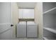 Convenient laundry room equipped with a full-size washer and dryer, plus overhead cabinet storage at 1276 Lanier Ne Blvd, Atlanta, GA 30306