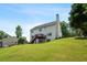 Rear exterior of the home featuring a deck and chimney amidst a green landscape at 140 Melrose Creek Dr, Stockbridge, GA 30281