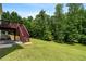 Expansive backyard featuring a wooden deck with stairs leading to a lush, green lawn at 140 Melrose Creek Dr, Stockbridge, GA 30281