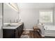 Bright bathroom features a double sink, granite counters, and separate tub at 140 Melrose Creek Dr, Stockbridge, GA 30281