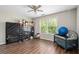 Bedroom features hardwood floor, window, and ceiling fan at 140 Melrose Creek Dr, Stockbridge, GA 30281