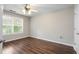 Bedroom features a hardwood floor, window, and ceiling fan at 140 Melrose Creek Dr, Stockbridge, GA 30281