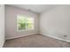 Bright bedroom with plush carpet and large window providing natural light at 140 Melrose Creek Dr, Stockbridge, GA 30281