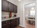 Butler's pantry showcasing granite counters and dark cabinetry at 140 Melrose Creek Dr, Stockbridge, GA 30281