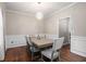 Cozy dining room featuring hardwood floors, designer lighting, and neutral walls at 140 Melrose Creek Dr, Stockbridge, GA 30281
