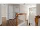 Upstairs hallway with hardwood floors and natural light at 140 Melrose Creek Dr, Stockbridge, GA 30281