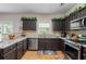 Spacious kitchen with granite countertops, stainless appliances, and tile floors at 140 Melrose Creek Dr, Stockbridge, GA 30281