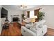 Inviting living room featuring a fireplace, ceiling fan, and hardwood flooring at 140 Melrose Creek Dr, Stockbridge, GA 30281