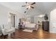 Spacious main bedroom features a wood floor, vaulted ceiling, and a ceiling fan at 140 Melrose Creek Dr, Stockbridge, GA 30281