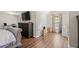 Bright main bedroom features a hardwood floor, TV, and vaulted ceiling at 140 Melrose Creek Dr, Stockbridge, GA 30281