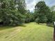 Expansive backyard featuring a lush lawn and mature trees, offering privacy at 349 Bald Rock Rd, Oxford, GA 30054
