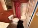 Small bathroom with a shower featuring an elaborate red curtain at 349 Bald Rock Rd, Oxford, GA 30054