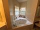 Bathroom featuring a jacuzzi tub and natural light at 349 Bald Rock Rd, Oxford, GA 30054