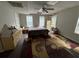 Spacious bedroom with ceiling fan, hardwood floors, and natural light from multiple windows at 349 Bald Rock Rd, Oxford, GA 30054