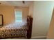 Bedroom featuring a floral patterned quilt, window with blinds, and a decorative wooden headboard at 349 Bald Rock Rd, Oxford, GA 30054