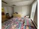 Bedroom featuring a colorful bedspread, hardwood floors, and a window with natural lighting at 349 Bald Rock Rd, Oxford, GA 30054