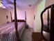 Bedroom with a four poster bed, mirror, and small window at 349 Bald Rock Rd, Oxford, GA 30054