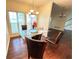 Dining room with modern chandelier, hardwood floors, and view of the stairway at 349 Bald Rock Rd, Oxford, GA 30054