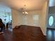 Open-concept dining room features a chandelier, wood floors and view to living room at 349 Bald Rock Rd, Oxford, GA 30054