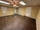 A room with vinyl floors, three windows, and a door leading outside at 349 Bald Rock Rd, Oxford, GA 30054