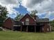 Exterior backyard showcasing a spacious deck, screened porch, and lush green lawn at 349 Bald Rock Rd, Oxford, GA 30054