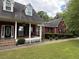 Lovely red brick home featuring a welcoming porch and lush green lawn at 349 Bald Rock Rd, Oxford, GA 30054