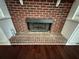 Brick fireplace with white mantle and built-in shelves at 349 Bald Rock Rd, Oxford, GA 30054