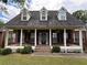 Charming home with a large, inviting front porch, perfect for relaxing and enjoying the outdoors at 349 Bald Rock Rd, Oxford, GA 30054