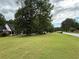 Expansive front lawn with mature trees surrounding an attractive brick home at 349 Bald Rock Rd, Oxford, GA 30054