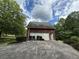 Detached two-car garage with ample parking space, located on a well-maintained property at 349 Bald Rock Rd, Oxford, GA 30054