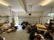 Cluttered two car garage featuring an automatic door and side storage space at 349 Bald Rock Rd, Oxford, GA 30054