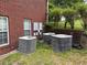 Exterior shot featuring three HVAC units beside a brick home and green shrubbery at 349 Bald Rock Rd, Oxford, GA 30054