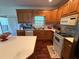 Well-lit kitchen features wood cabinets, white appliances, and a bright window over the sink at 349 Bald Rock Rd, Oxford, GA 30054