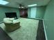 Living room with dark floors, a cream-colored shag rug, a TV and one couch at 349 Bald Rock Rd, Oxford, GA 30054