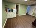 A living room with plank floors and a wet bar with sink and microwave at 349 Bald Rock Rd, Oxford, GA 30054