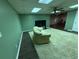 Living room with dark floors, a cream-colored shag rug, a TV and one couch at 349 Bald Rock Rd, Oxford, GA 30054