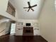 Spacious living room with high ceiling, hardwood floors, and cozy fireplace at 349 Bald Rock Rd, Oxford, GA 30054