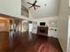 Open-concept living room features a fireplace with built-ins, a ceiling fan and stairs at 349 Bald Rock Rd, Oxford, GA 30054