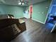 Spacious living room with an old organ, ceiling fan and wood flooring at 349 Bald Rock Rd, Oxford, GA 30054