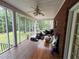 Enclosed porch with screens features a ceiling fan, wood floors, and a view of the yard at 349 Bald Rock Rd, Oxford, GA 30054