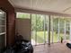 View of the backyard from the screened-in porch with access to a wood deck at 349 Bald Rock Rd, Oxford, GA 30054