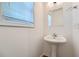 Bathroom featuring pedestal sink and window with natural light at 1331 Memorial Se Dr, Atlanta, GA 30317